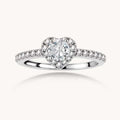 Heart-shaped halo ring with brilliant moissanite center stone surrounded by smaller crystals in sterling silver setting
