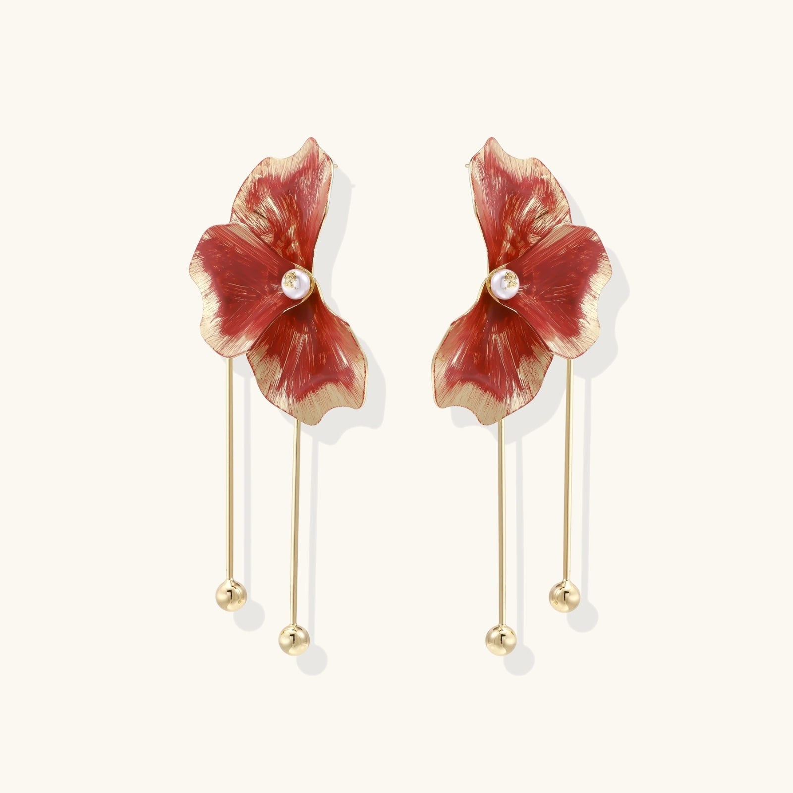 Red enamel flower earrings with gold-plated stems, central pearl, and gradient coral-to-gold petals on white background